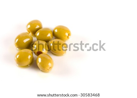Several olives on white background filled with oil