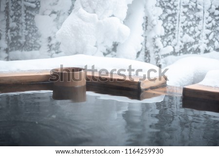Japan natural mineral hot spring called onsen cover by snow in Japanese ryokan on the moutain okuhida takayama japan