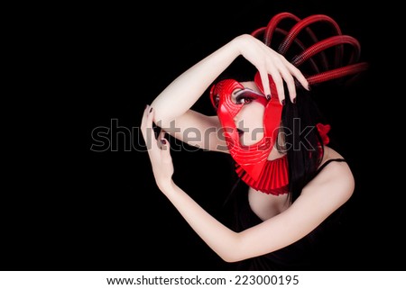 Beautiful young woman with red futuristic face mask
