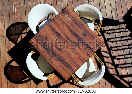 Table and four chairs on wood floor, silhouettes