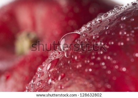 food background. red wet apple with big drops. macro