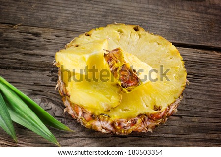 Pineapple. Slice and chunks on wooden table