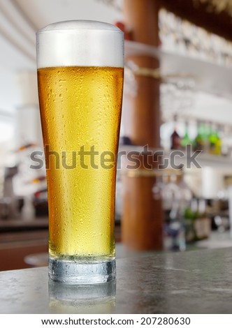 Glass of light beer in a pub.