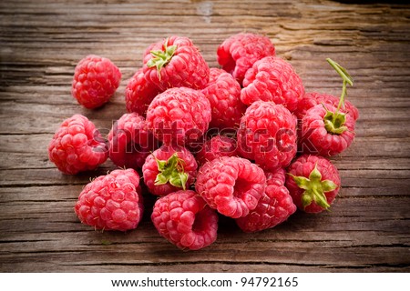 Fresh organic fruit - raspberry on wood background selective focus