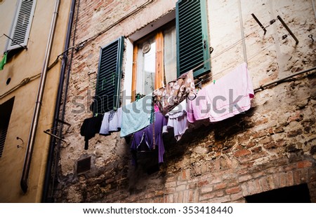 photo of colored clothes drying on the balcony