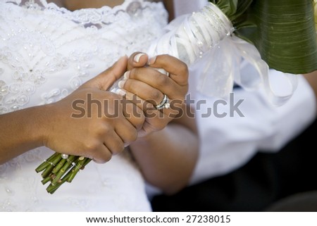 An African-American bride holding her bouquet after the wedding ceremony