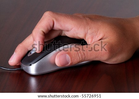 A close up of a man working with a computer mouse