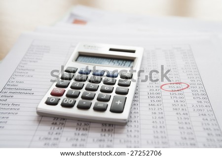 Calculator on personal finance documents.  Logos, numbers, signature etc have been removed or changed to make unidentifiable.