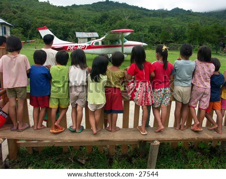 Children are watching pioneer plane type casa at borneo Indonesia.