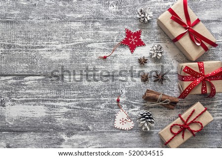 Background with gift boxes, Christmas ornaments and spices on gray wooden boards. Space for text. Top view.