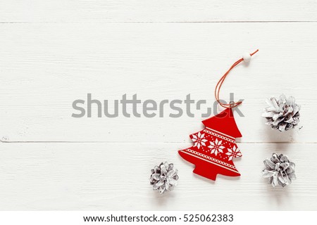 Christmas decoration fir- tree and pine cones on white boards. Top view. Space for text.