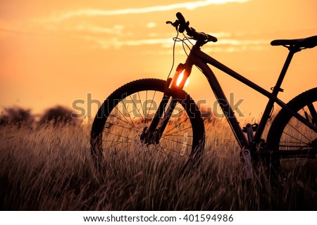 Silhouette Mountain biking at sunset