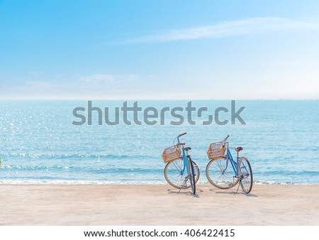 Two bicycle at the beach on blue sky