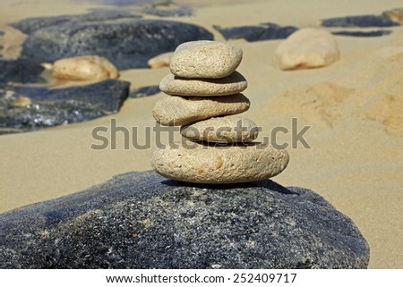 Yoga style balanced rocks on the beach.