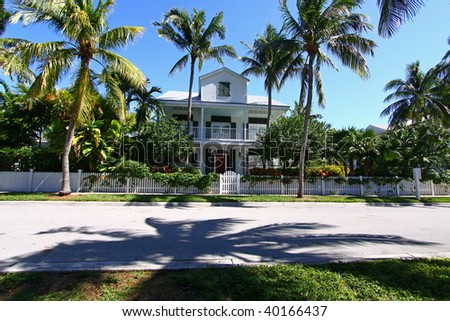 Typical Key West, Florida house surrounded by palm trees.