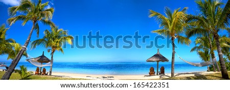 Panoramic View Of Mauritius Beach With Chairs And Umbrellas