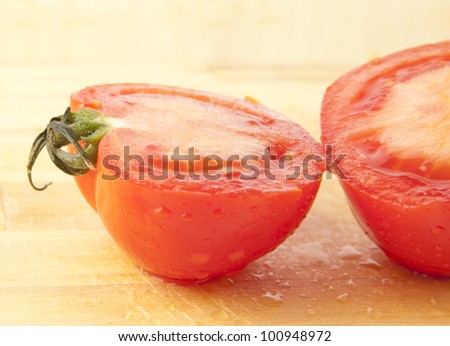 Slice Tomato on a Wooden Cutting Board  red ripe tomato sliced pieces on the kitchen blackboard