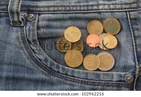 Pocket-money EURO-Cents coming out of jeans pocket
