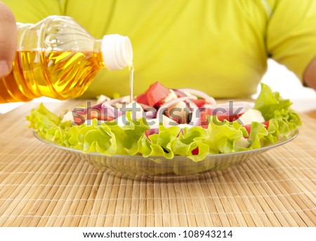 Greek salad and pouring olive oil, Greek cuisine