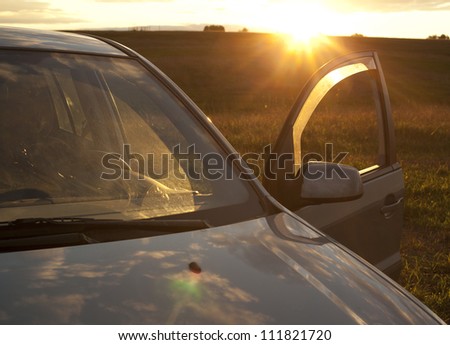 Car against sunset in the background  idea of ??environmentally friendly electric vehicle powered by the solar energy