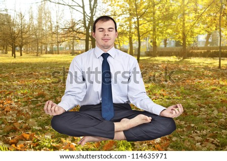 business man meditating in work shirt and tie.