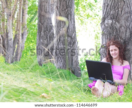 Woman sitting in park with a new laptop