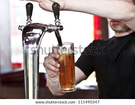 Filling glass with beer