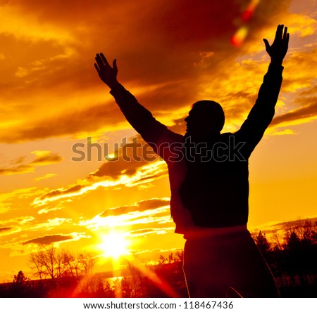 Meeting of the sun. The man on with the hands lifted above, on a background of a sunset