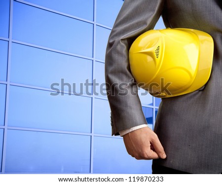 engineer yellow helmet for workers security on blue buildung background