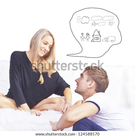 Closeup portrait of adult couple sitting on sofa at their apartment and planning renovation of their new apartment
