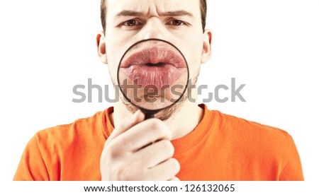 man in orange shirt with magnifying glass in front of her lips.