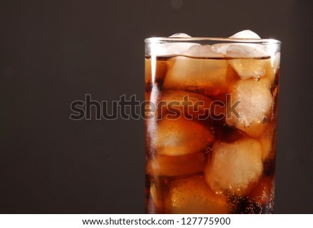 Cola. Coke glass on black background Space for inscription