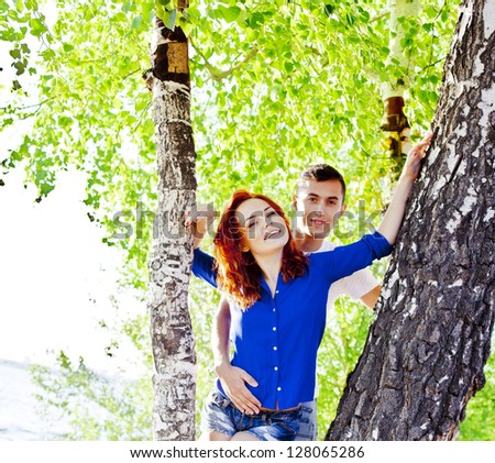 beautiful young couple embracing outdoors in the forest, true love and passion