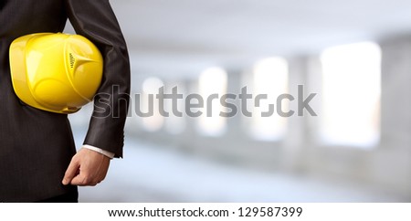 Engineer Yellow Helmet For Workers Security On The Background Of A Old Apartment Buildings Of Gray