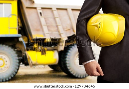 construction worker showing thumb up smiling in beside truck