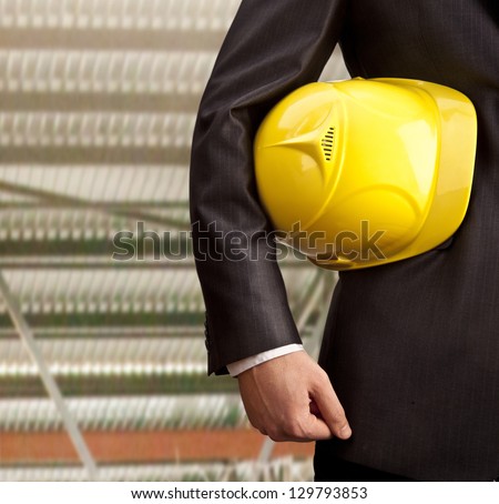 engineer yellow helmet for workers security  on gray building background