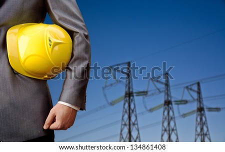 engineer yellow helmet for workers security over high voltage power lines