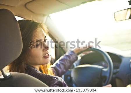 young woman in car - indoor keeps wheel turning around looking at passengers sitting side idea of  taxi driver talking to policeman companion companion who asks for directions right  drive Documents