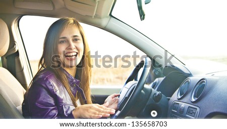 Portrait of beautiful young latin hispanic woman in the new car - indoor talking to an imaginary police, companion, companion, who asks for directions or the right to drive and Documents