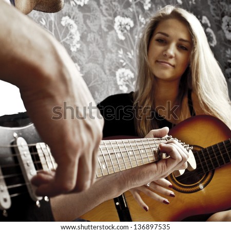 couple of guitarists of a rock band with a guitar
