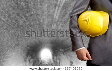 engineer yellow helmet for workers security over the gray tunnel at the prospect of leaving