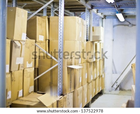 Warehouse shelf with cardboard boxes and goods  Interior of modern warehouse, many boxes