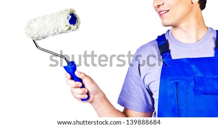 Male hand holding  paintroller over a white wall, ready to start painting