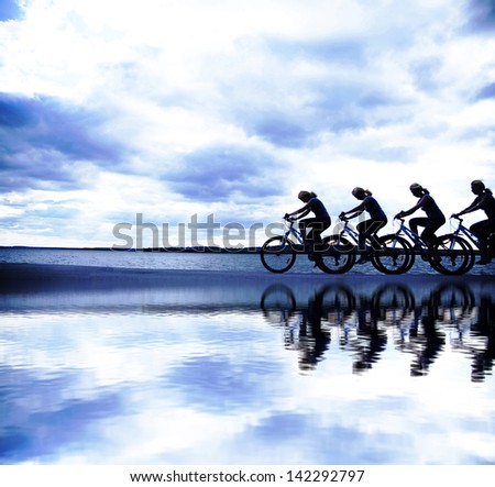 Image of sporty company friends on bicycles outdoors against sunset. Silhouette   The four phases of motion of a single cyclist along the shoreline coast