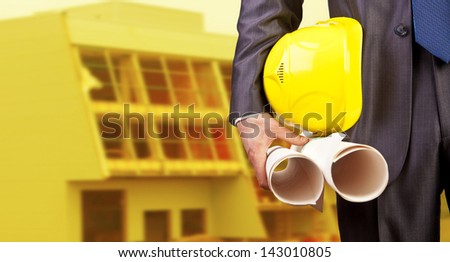 engineer yellow helmet for workers security on the background of a new high-rise apartment buildings