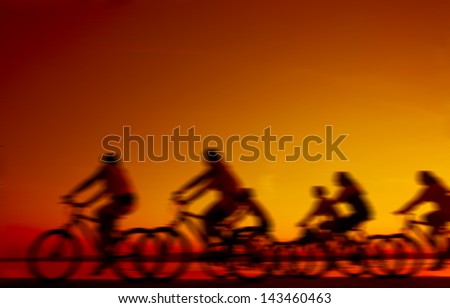 Image of sporty company friends on bicycles outdoors against sunset. Silhouette A lot phases of motion couple of  cyclist along the shoreline coast
