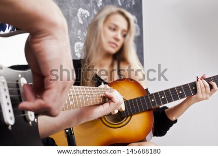 couple of guitarists of a rock band with a  electric and acoustic guitar Sad women Copy Space for insription