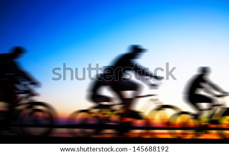 Image of sporty company friends on bicycles outdoors against sunset Silhouette  . A lot phases of motion of a single cyclist along the shoreline coast Space for inscription