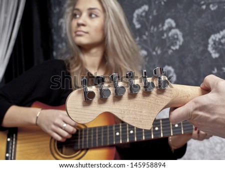 couple of guitarists of a rock band with a acoustic and electric guitar