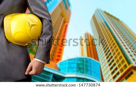 engineer yellow helmet for workers security over two high-rise buildings